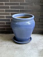 Front view of blue ceramic planter with saucer