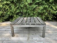 Full view of weathered square teak table front