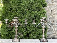 Front view of both silver plated five-arm candelabras