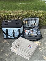Cooler, picnic case open displaying contents, and blanket