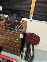 Overview of bags, briefcases, wallets on dresser