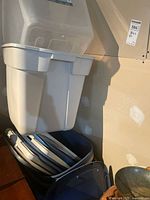 Stacked white tote with clear tote inside and lids beneath