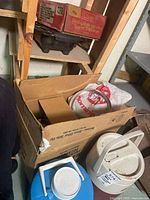 Overall lot showing camp stove box, electric grill below, cardboard box with burner elements and beverage coolers