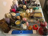 Tabletop view showing entire assortment of candles, holders, tapers in packaging