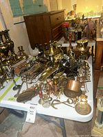 overall view of table filled with brass, copper and mixed metal items