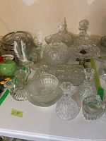 Overview of assorted cut glass pieces on table