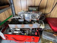 Overall view of toolbox, trays, assorted hardware inside and around