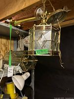Hexagonal brass glass lantern and partial view of other fixtures