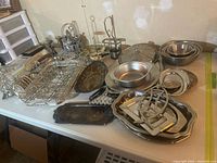 Overall lot showing trays, bowls, wire basket, mixer beaters