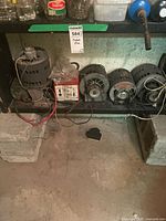 Shelf view showing four motors and battery charger