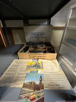 overall view of contents with box, track, cars and papers