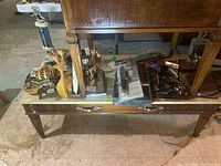 Overall view of coffee table holding trophies, wood items and knives