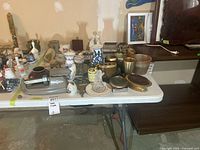 Overall table view showing postal scale, vases, brass items and figurines