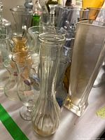 Group of assorted glass vases and bottles on table