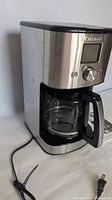 Cuisinart stainless steel drip coffeemaker with carafe and power cord visible