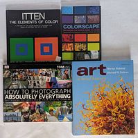 Overview of all four books arranged on surface
