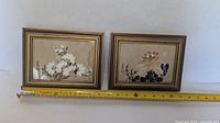 Both framed floral silk paintings with measuring tape for scale