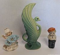 Front view of swan vase, angel and boy figurines