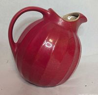 Left side view showing ribbed body, handle, glaze condition