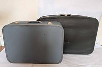 Exterior of both suitcases closed showing size comparison and handles