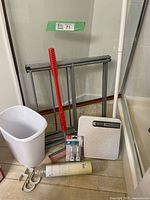 Full lot showing drying rack, wastebasket, shower curtain rod, bath mat roll, scale, nightlights