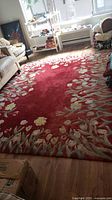 overall view of garnet floral area rug on floor