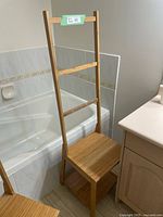 Front view of wooden ladder-back chair showing seat and three rungs