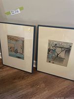 Both framed drawings standing on floor showing full frames