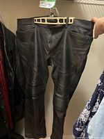 Full view of black leather pants front