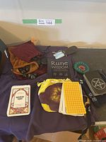 Overview showing Rune Wisdom book, tarot decks, rune stones, pouches