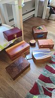 Group view of all eight small wooden boxes on floor