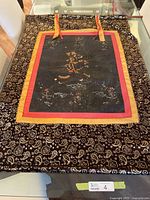 Full view of Thangka with brocade border and hanging tabs