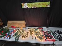 Entire lot displayed on table with stocking stand, lights, garland, timers