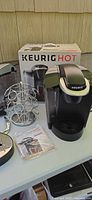 Overall lot showing Keurig brewer, carousel, manual and box