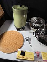 Coffee urn, steamer insert, colander, bamboo board, scoop, oven liner box