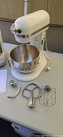 KitchenAid mixer, bowl, three attachments in view