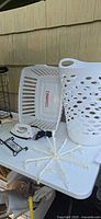 Overview with white perforated hamper, rectangular basket, iron, drying rack