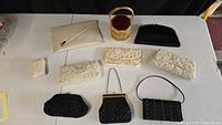 Overview of 9 handbags and clutches on table