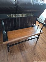Full view of Hitchcock bench showing wood seat, black frame and stencil