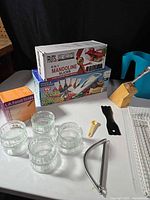 Overview showing mandoline slicer boxes, ramekins, utensil block, wire rack