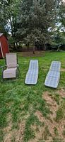 Zero-gravity recliner and two folding chaises on lawn