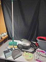 Overall view with Shark vacuum, green flat mop, dustpans, spin bucket and accessory pieces