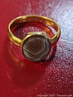 Full view of ring showing banded agate cabochon and gold bezel