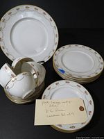 Stacked porcelain plates, teacups and saucers showing full set