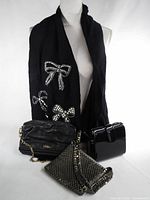 Group shot showing scarf draped on mannequin, Cole Haan leather bag, patent handbag, silver mesh clutch