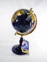 Full view of gemstone globe on stand with tag attached