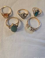 All five 10K gold rings arranged on cloth