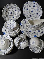 Overall view of Mason's Blue Denmark dinnerware set, stacked plates, bowls, cups, gravy boat
