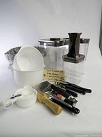 All items arranged showing storage containers, bowls, utensils