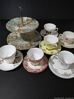 Group shot of cake stand with six cup & saucer sets